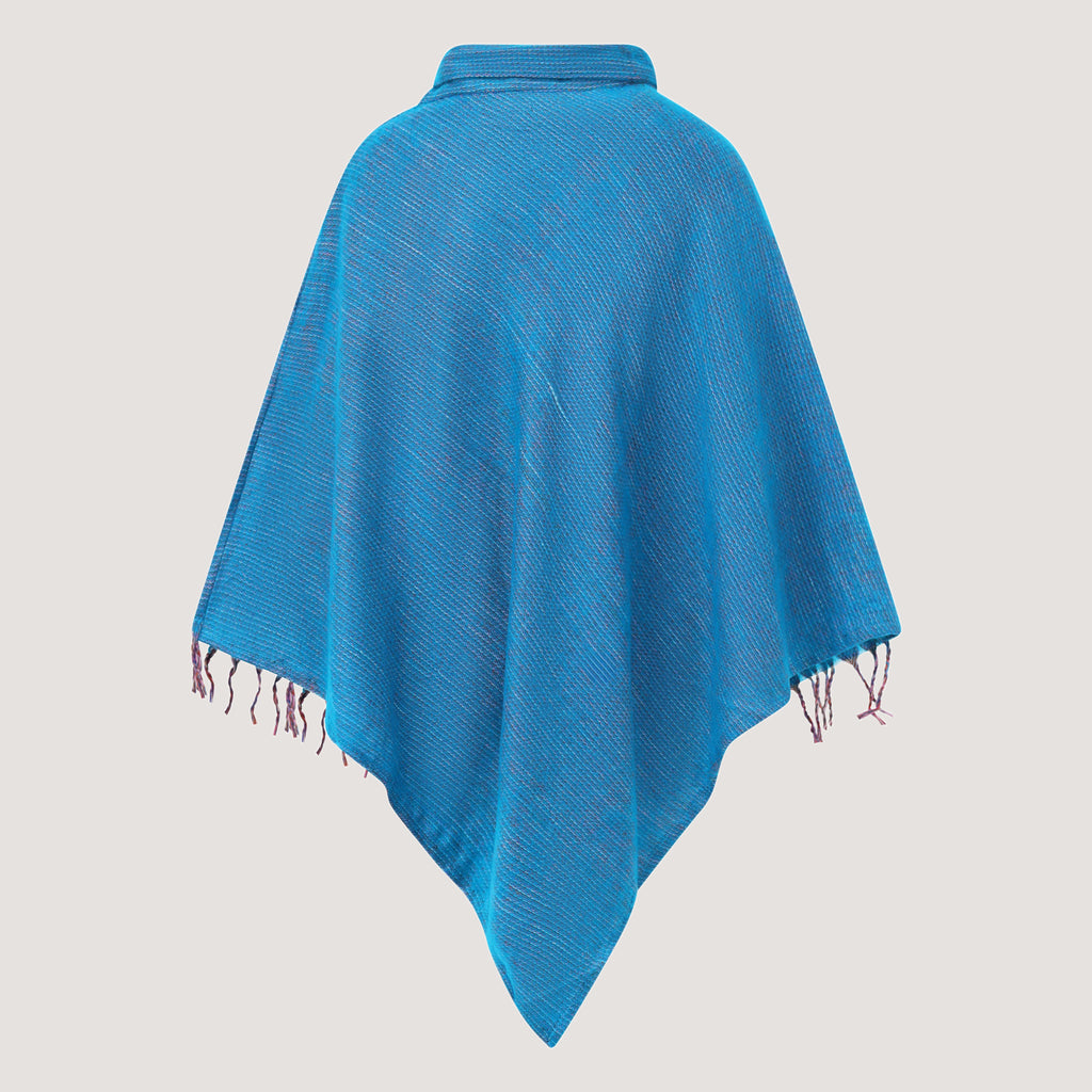 Blue cowl neck poncho featuring kantha embroidery and a fringed hemline designed by OMishka