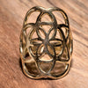 An adjustable, artisan handmade pure brass, seed of life ring designed by OMishka.