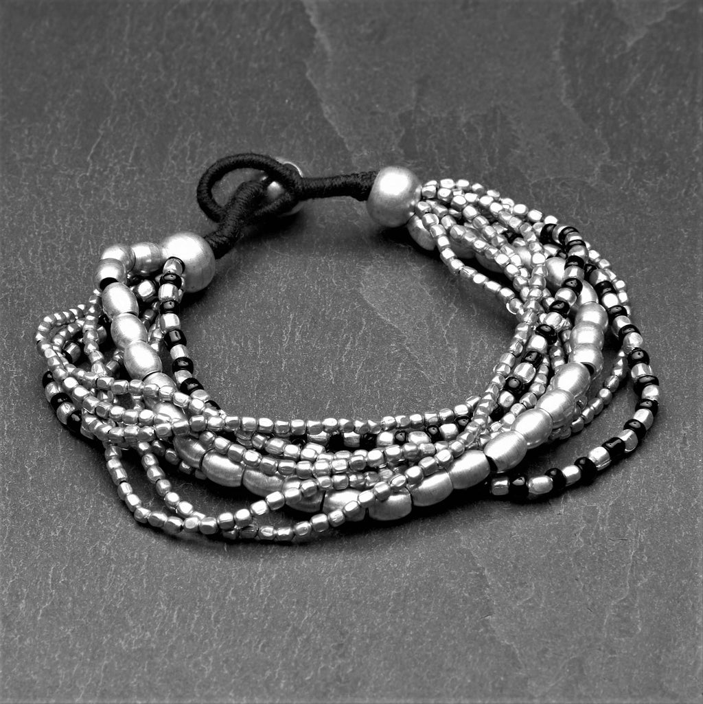 Artisan handmade silver toned brass and black glass beaded, multi strand bracelet designed by OMishka.