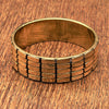 A chunky, patterned pure brass bangle bracelet designed by OMishka.