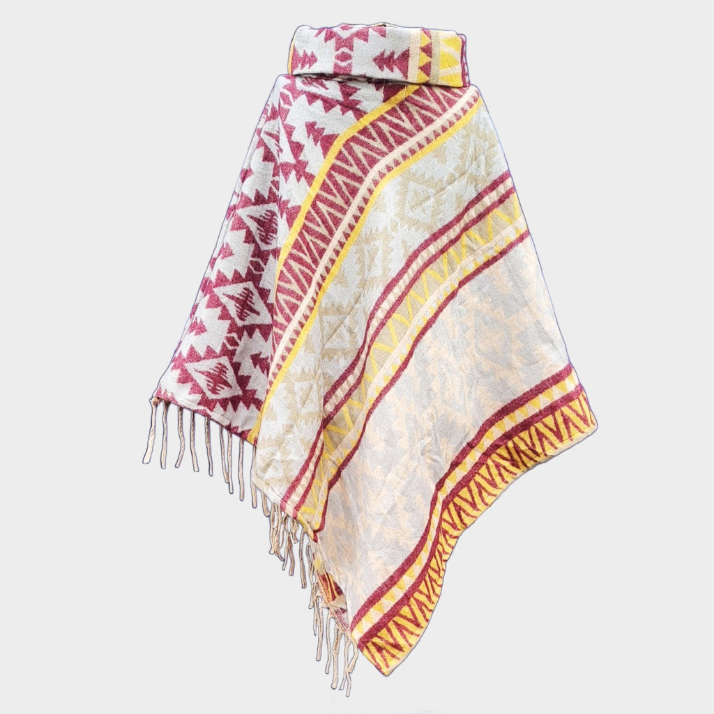 Colorful yellow and red patterned poncho with fringes on a light gray background