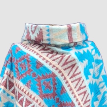 Colorful patterned bamboo poncho with an Aztec design on a light gray background
