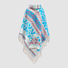 Colorful blue patterned poncho with fringes on a light gray background