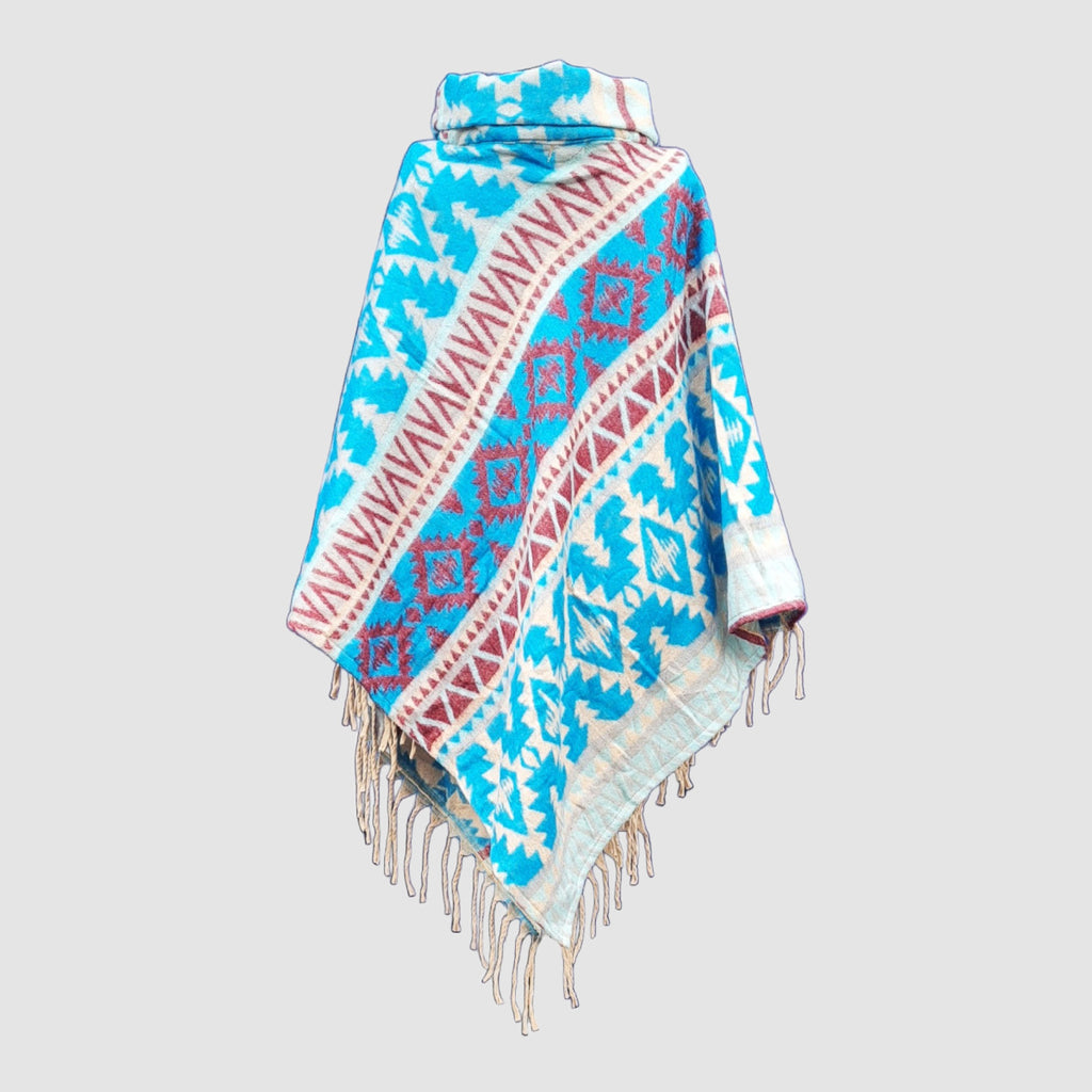 Colorful blue and red patterned poncho with fringes on a light gray background