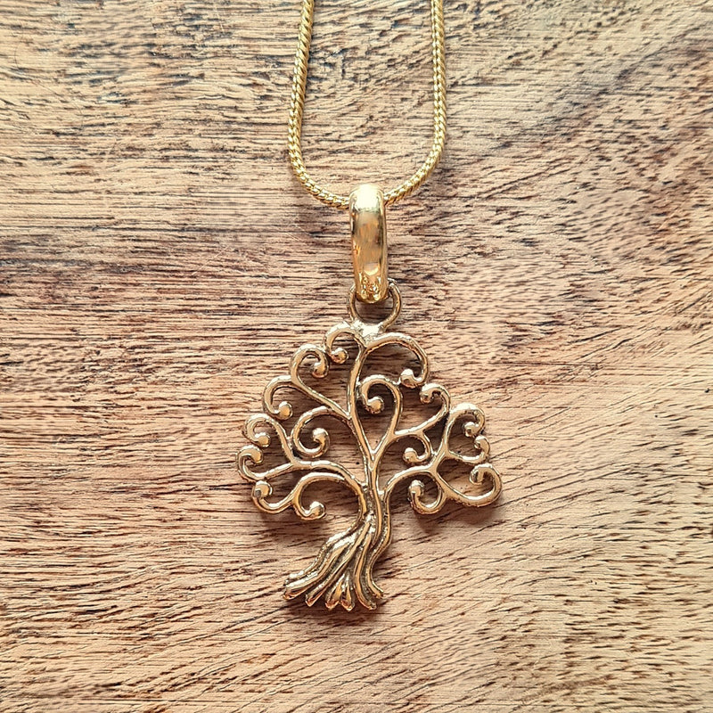 Brass open tree of life design pendant.
