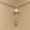 Brass necklace with a lotus flower and a Unalome design.