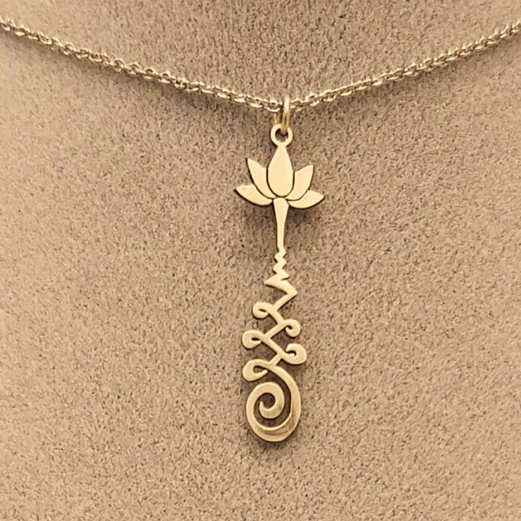Brass necklace with a lotus flower and a Unalome design.