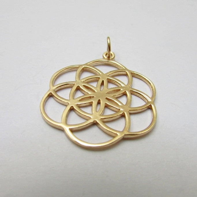 Gold coloured pure brass seed of life pendant.