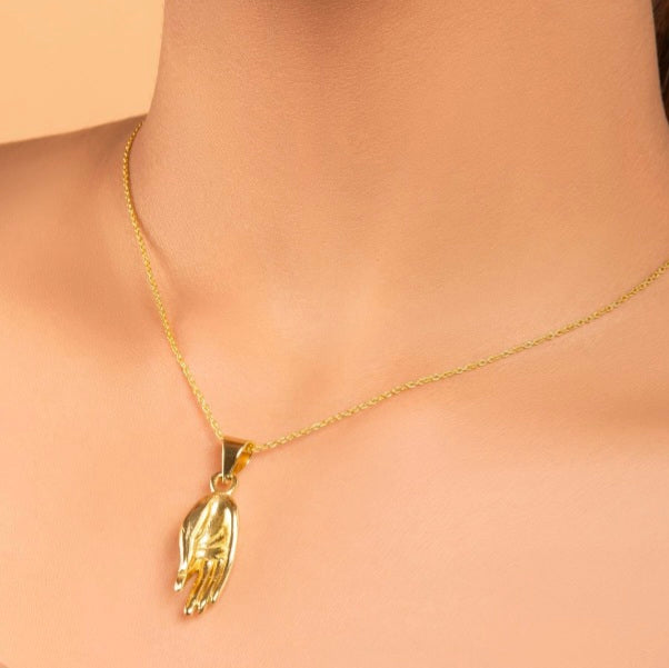 Brass Lord Buddha hand pendant.