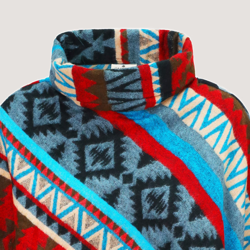 Blue mix coloured, super soft bamboo poncho, Aztec patterned with a fringed hem designed by OMishka