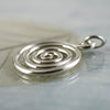 Silver open spiral pendant necklace.