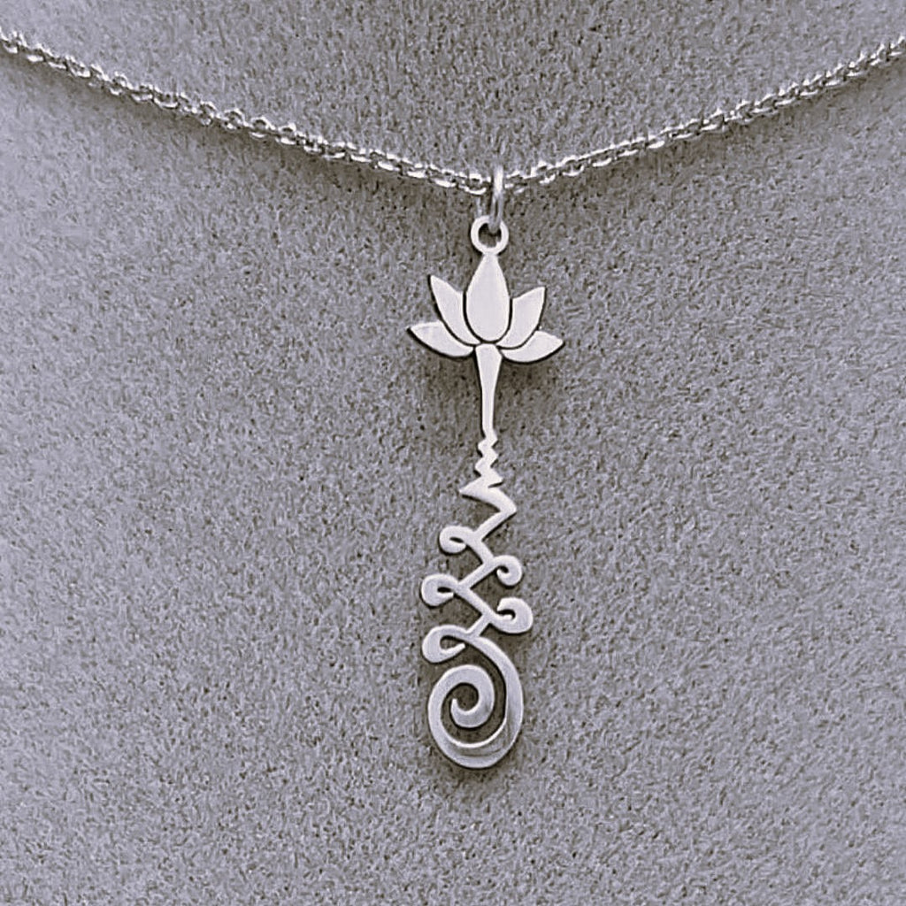 Silver necklace with a lotus flower and a Unalome design.