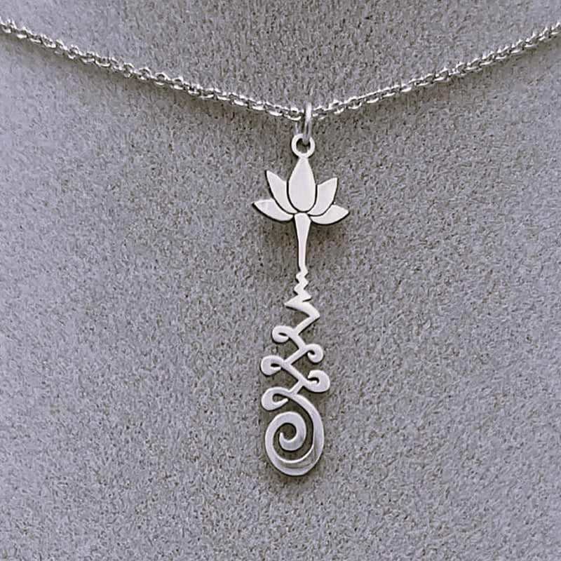 Silver necklace with a lotus flower and a Unalome design.