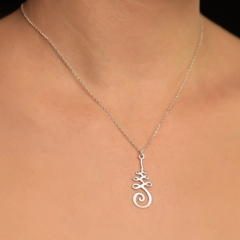 Silver necklace with a spiritual Unalome pendant on a silver chain.
