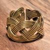 An adjustable, chunky, artisan handmade, open braided pure brass ring designed by OMishka.