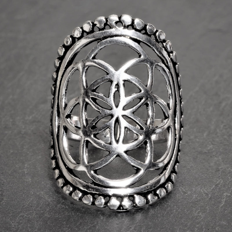 An adjustable, chunky, artisan handmade solid silver, beaded seed of life ring designed by OMishka.