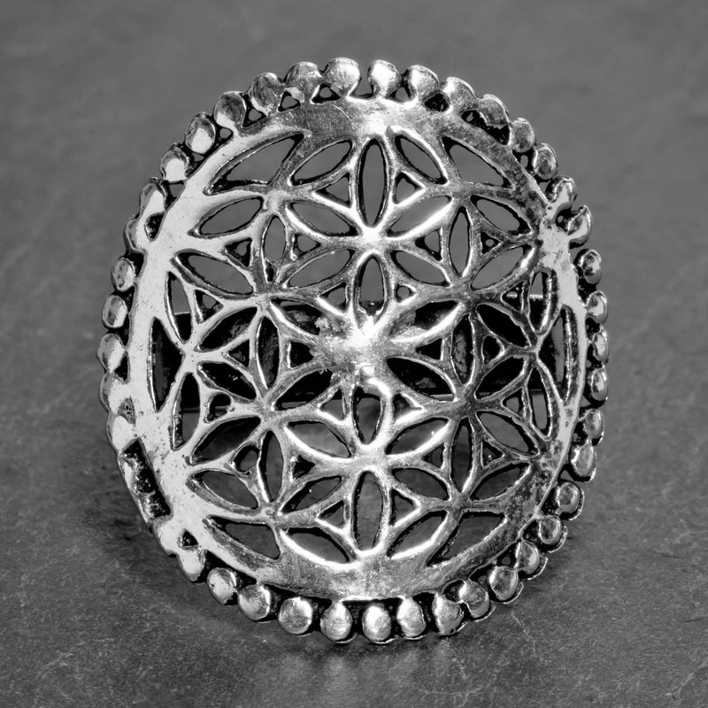 A large, adjustable, artisan handmade solid silver, beaded flower of life ring designed by OMishka.