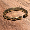 An adjustable, dainty pure brass dotted and swirl patterned band toe ring designed by OMishka.