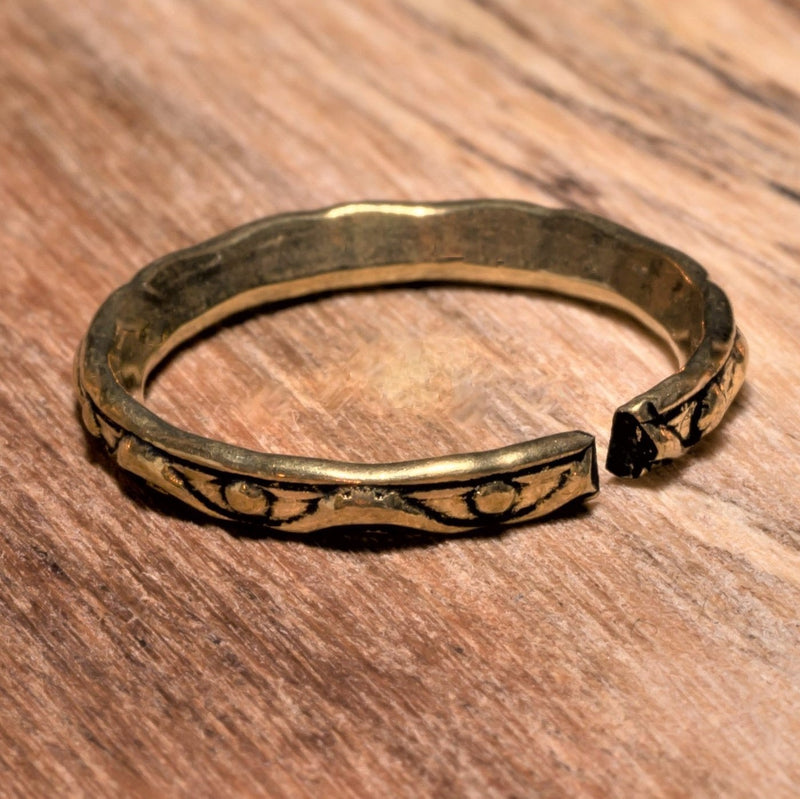 An adjustable, dainty pure brass dotted and swirl patterned band toe ring designed by OMishka.