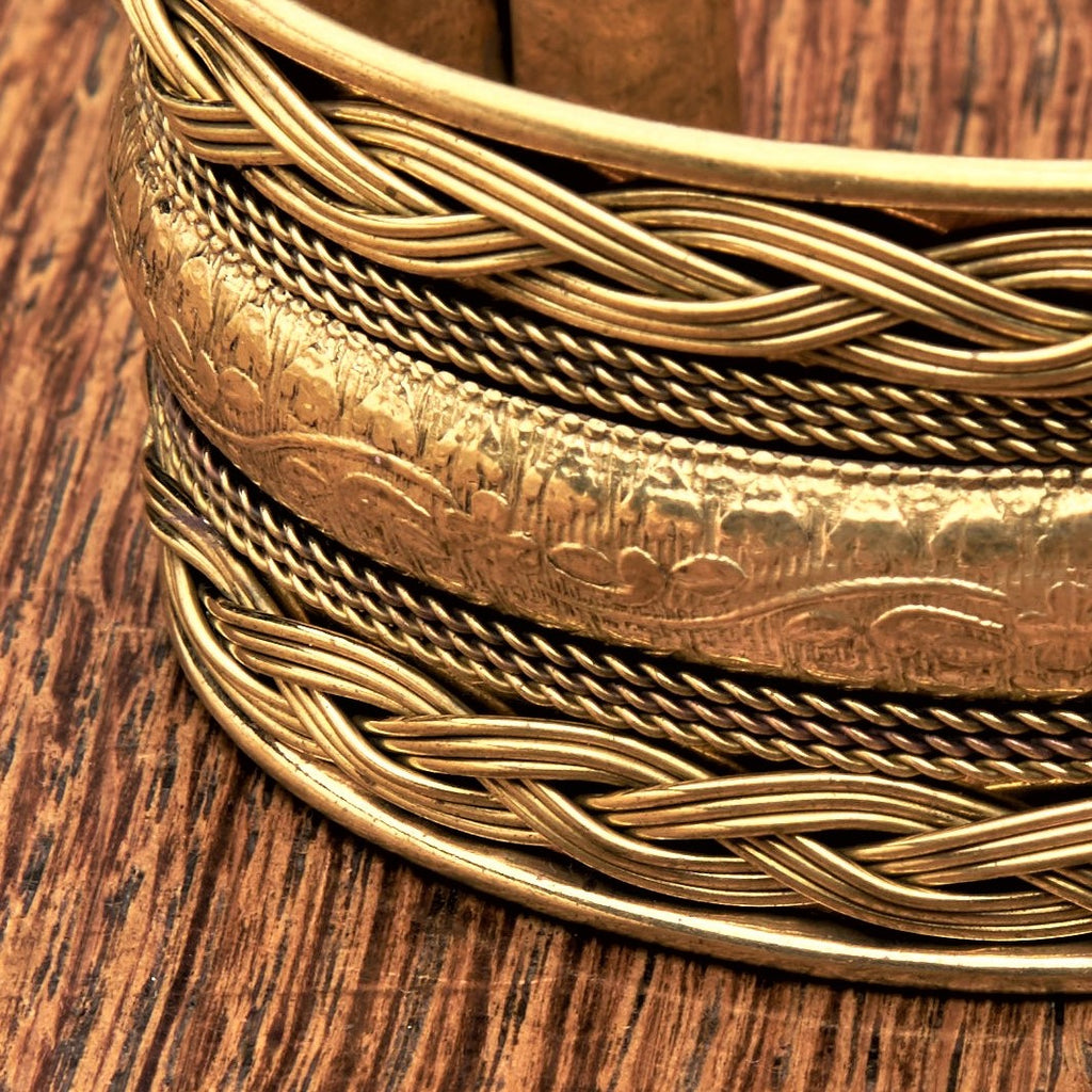 An adjustable pure brass, floral patterned woven cuff bracelet designed by OMishka.