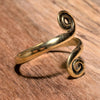 An adjustable, dainty, pure brass open spiral wrap toe ring designed by OMishka.