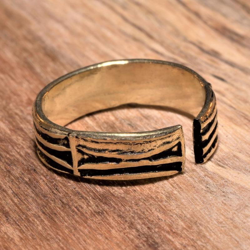 An adjustable, pure brass, etched tree bark patterned band toe ring designed by OMishka.