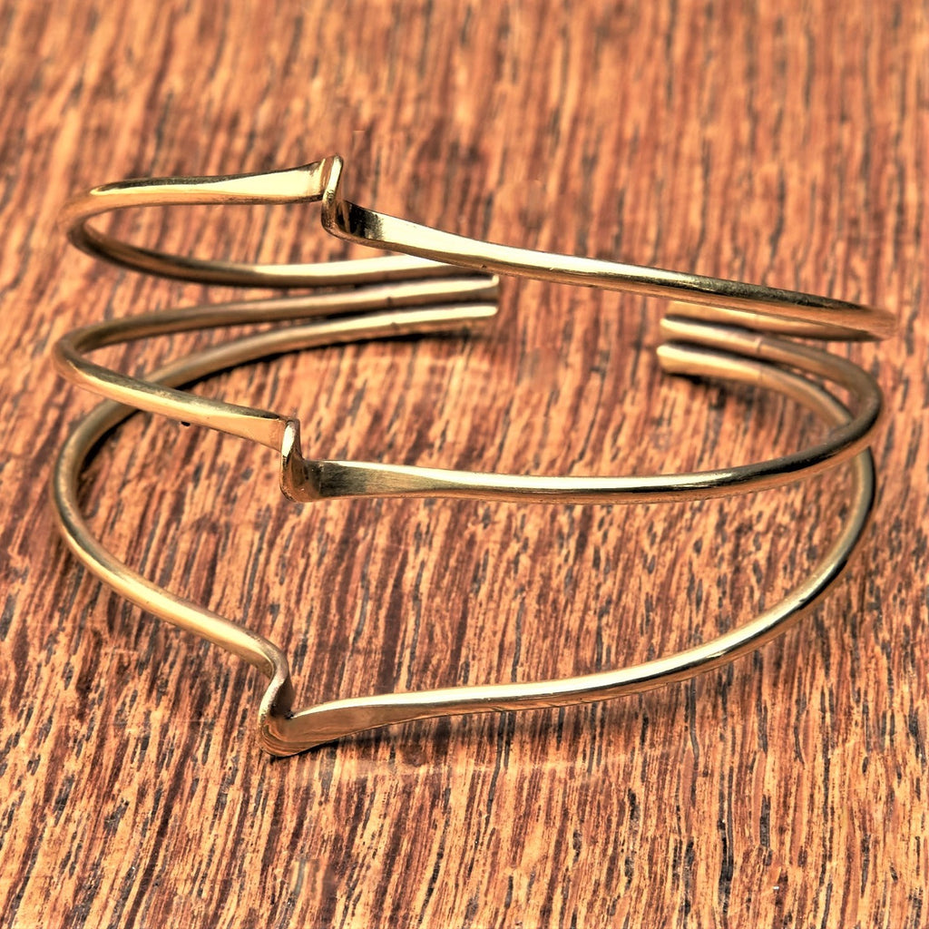 An adjustable, pure brass triple wave bracelet cuff designed by OMishka.