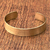 An adjustable, brushed pure brass simple cuff bracelet designed by OMishka.