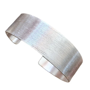 An adjustable, brushed silver simple cuff bracelet designed by OMishka.