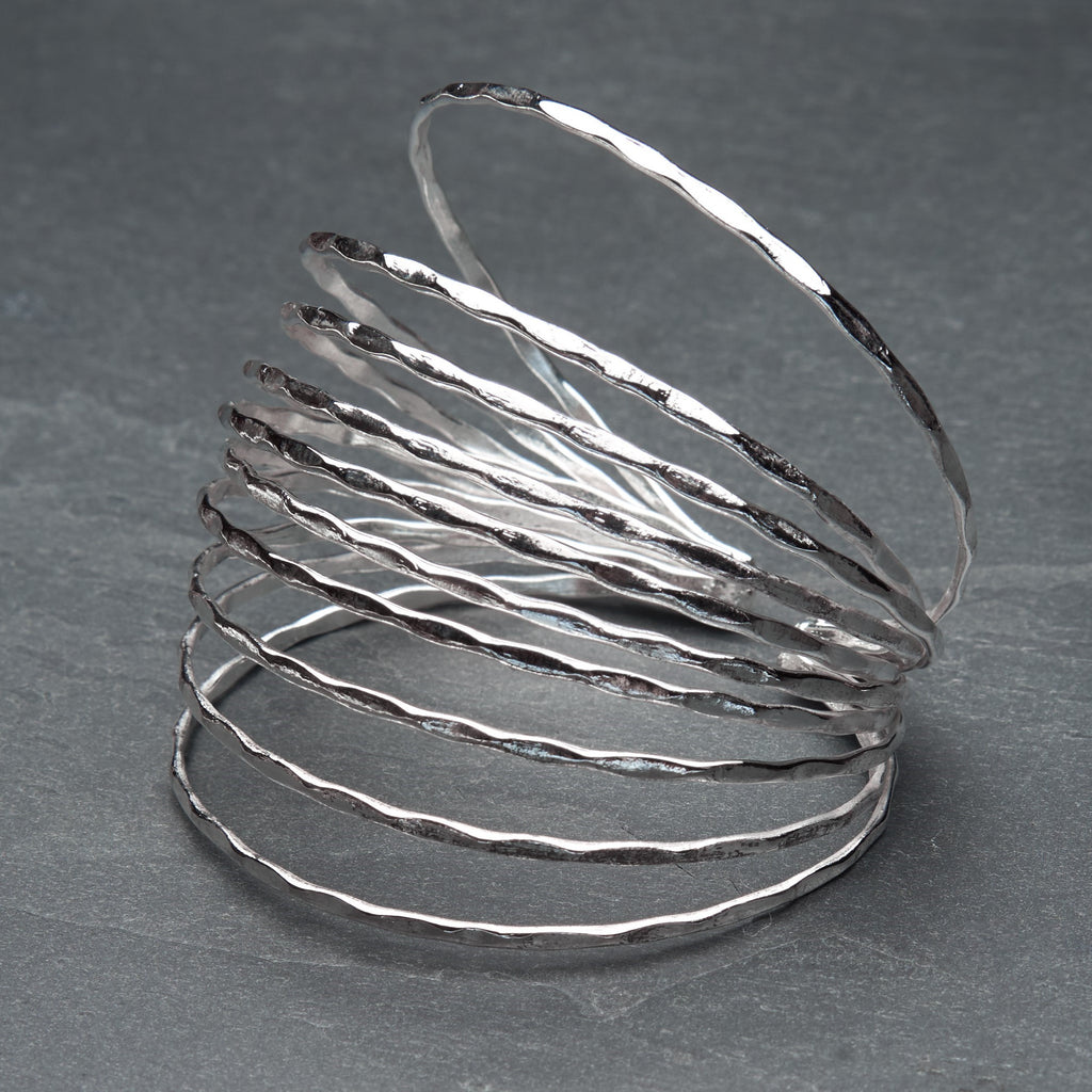 An adjustable hammered silver, multi strand bracelet cuff designed by OMishka.