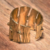 An adjustable, chunky, handmade pure brass band, tree bark textured ring designed by OMishka.