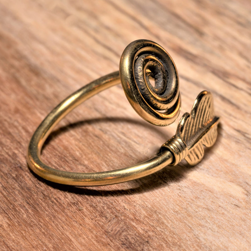 An adjustable, handmade pure brass, feather spiral wrap ring designed by OMishka.