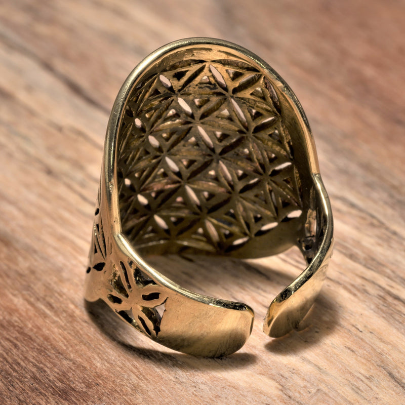 An adjustable, chunky, handmade pure brass flower of life ring designed by OMishka.