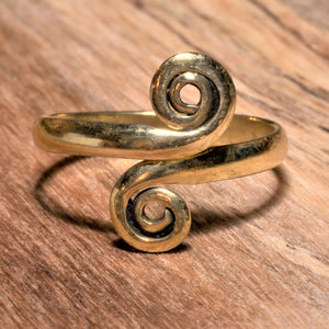 A dainty, adjustable, handmade pure brass open spiral wrap toe ring designed by OMishka.