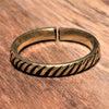 An adjustable, handmade, dainty pure brass striped patterned band toe ring designed by OMishka.