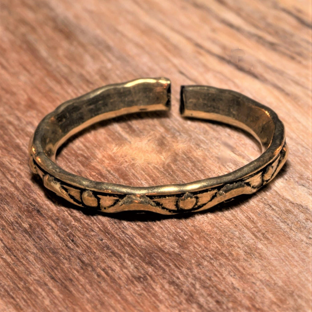 An adjustable, handmade, dainty pure brass dotted and swirl patterned band toe ring designed by OMishka.