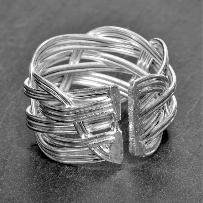 An adjustable, handmade and chunky, open weave plaited solid silver ring designed by OMishka.