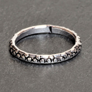 An adjustable, dainty solid silver dotted band toe ring designed by OMishka.