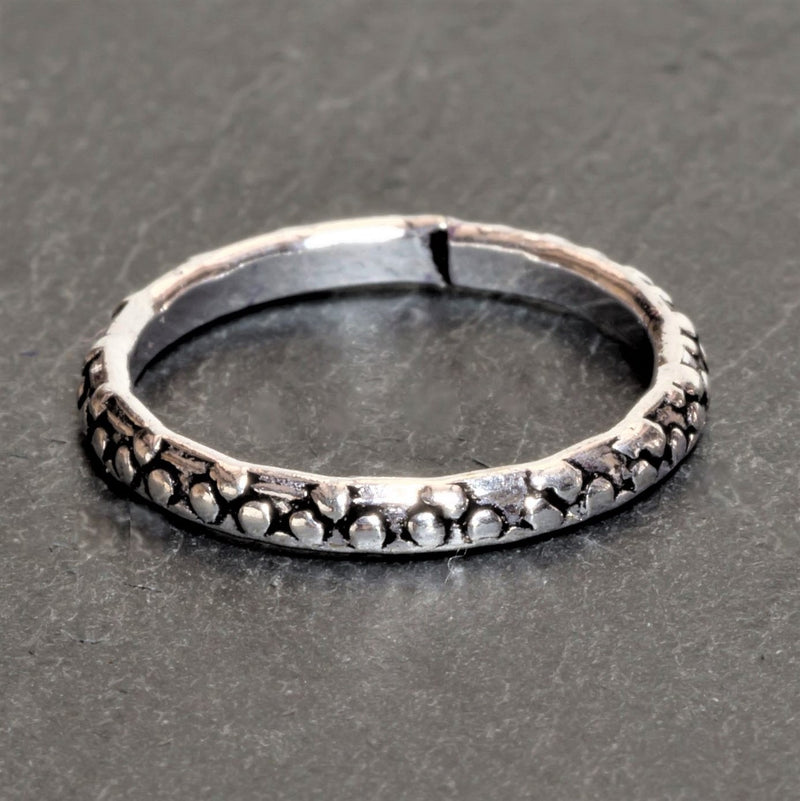 An adjustable, dainty solid silver dotted band toe ring designed by OMishka.