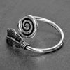 An adjustable, handmade solid silver, feather spiral wrap ring designed by OMishka.