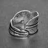 An adjustable, handmade solid silver, feather wrap ring designed by OMishka.