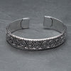 An adjustable, handmade silver spiral patterned cuff bracelet designed by OMishka.