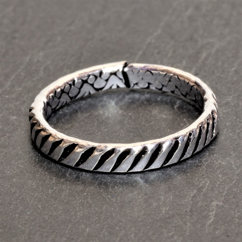 An adjustable, handmade, dainty solid silver striped patterned band toe ring designed by OMishka.