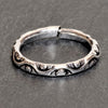 An adjustable, handmade, dainty solid silver dotted and swirl patterned band toe ring designed by OMishka.