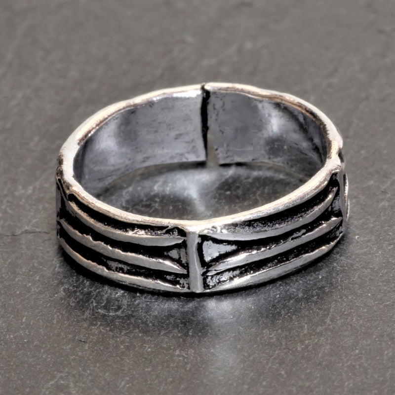 An adjustable, handmade solid silver, etched tree bark patterned band toe ring designed by OMishka.