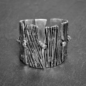 An adjustable, chunky, nickel free solid silver, tree bark textured ring designed by OMishka.