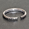 An adjustable, dainty, dotted solid silver band toe ring designed by OMishka.