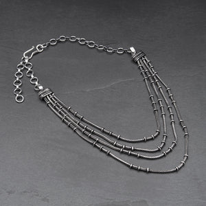 Handmade silver toned white metal, layered four strand, subtle beaded, adjustable snake chain necklace designed by OMishka.
