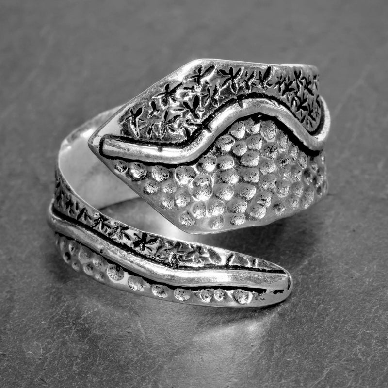 An adjustable, chunky solid silver, dotted swirl patterned wrap ring designed by OMishka.