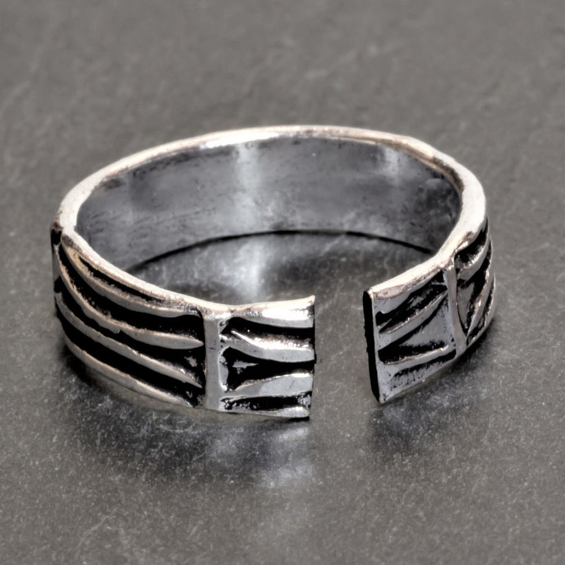 An adjustable, solid silver etched tree bark patterned band toe ring designed by OMishka.